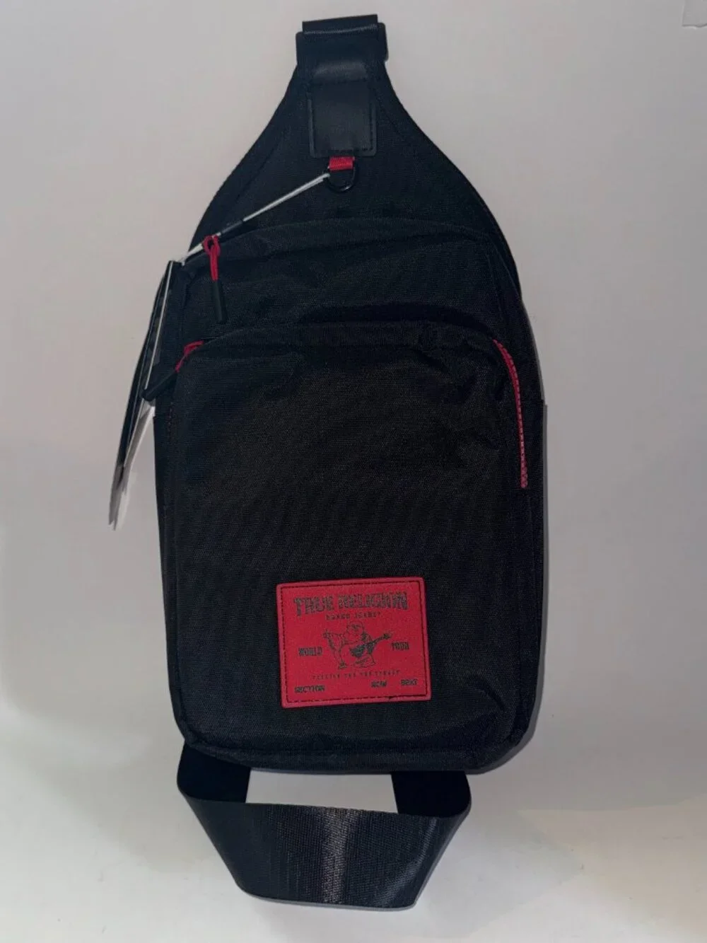 True Religion Sling Bag Features a Textured Brand Patch Durable Nylon With Red